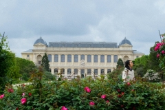 Botanical-gardens-woman-looks-at-flowers