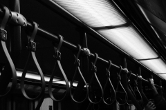 hands-upon-the-railings-tram-BnW