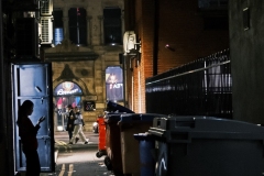 Chinatown-woman-in-door-with-people-walking-by-EDIT