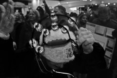 woman-bangs-tambourine-in-crowd-BnW